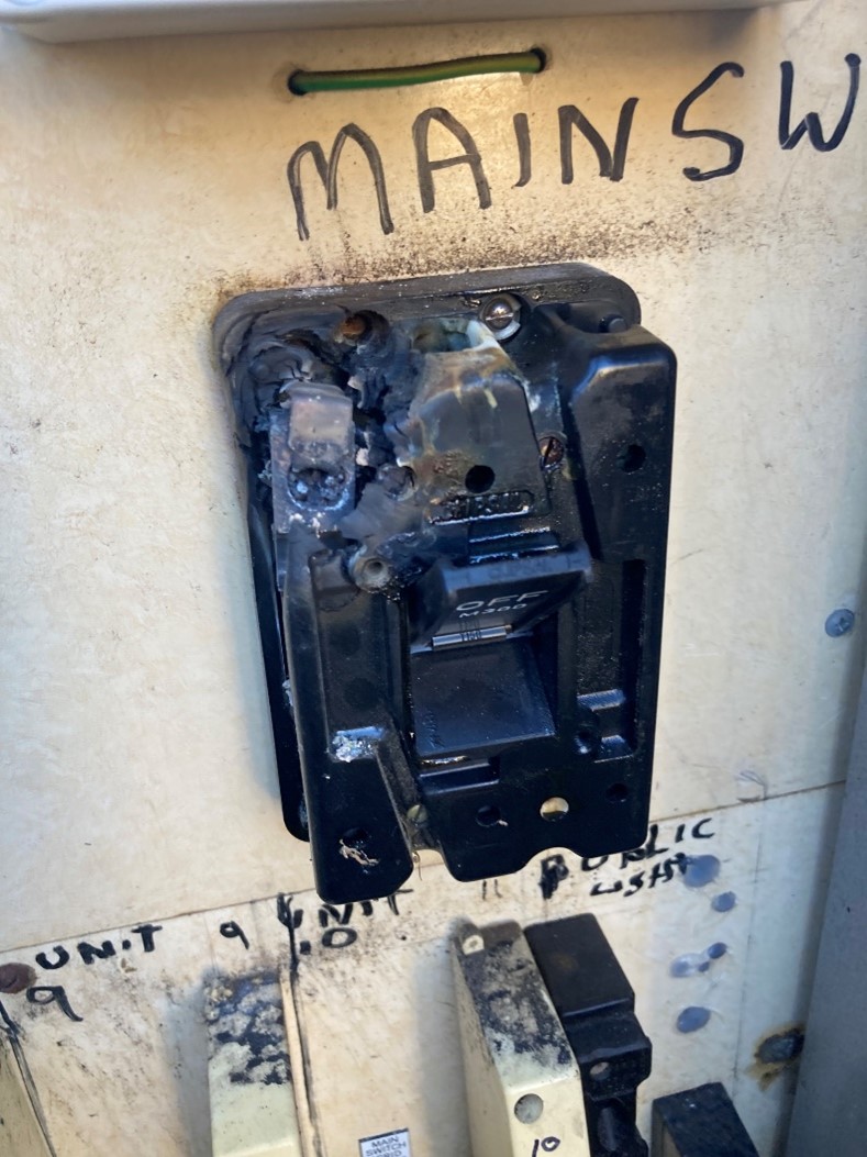 A multi-tenancy or community electrical switchboard showing signs of melting from overheating in Adelaide